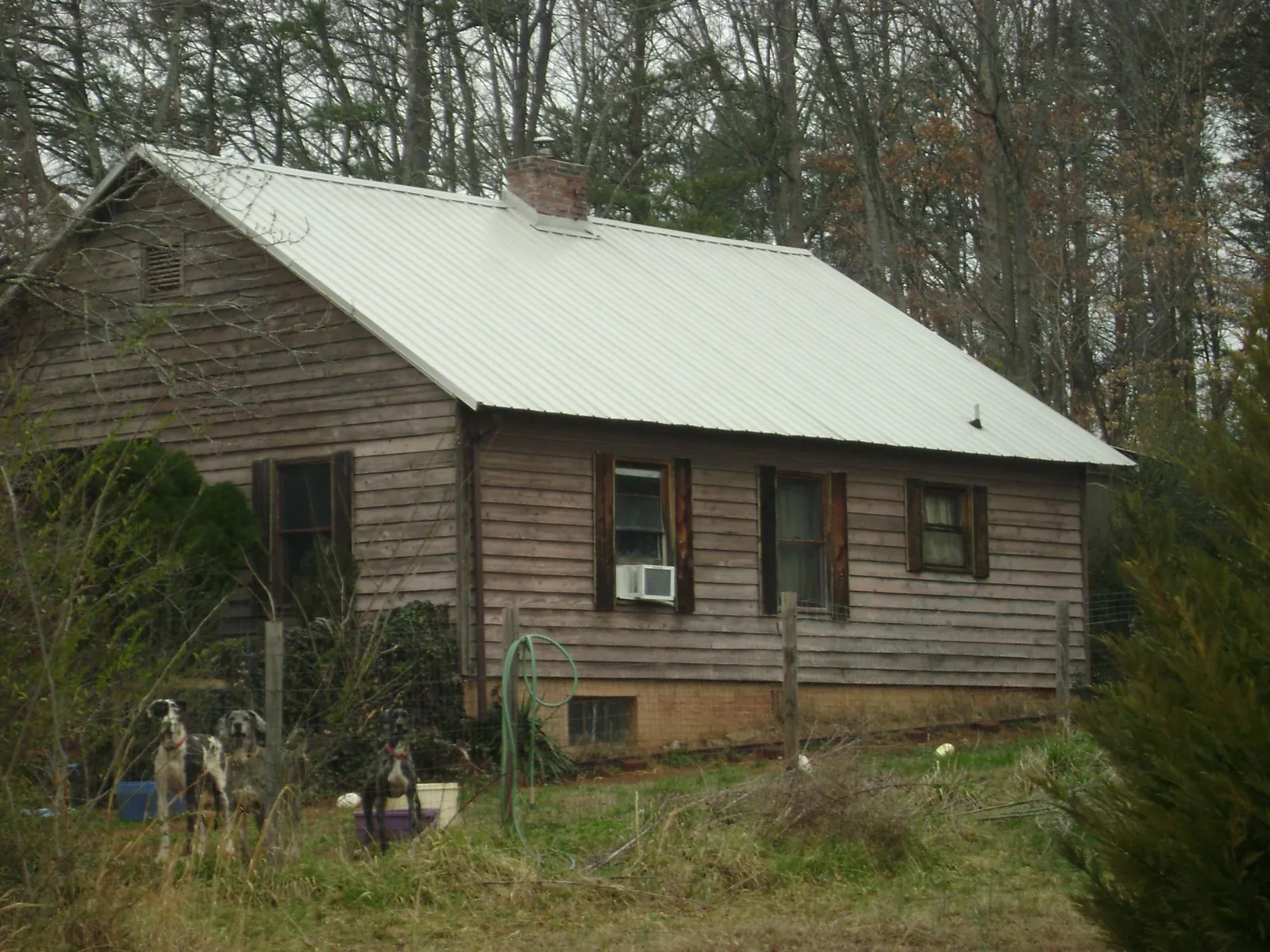 White metal roof on an old wood sided farmhouse, from a Metal Roof Installation job in Berkley
